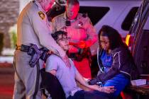 Metro officer Anthony Manginelli, left, helps calm suspect Mike Soto as phlebotomist Ashley Web ...
